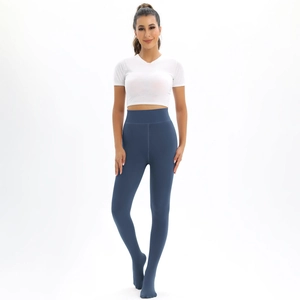 Front view of women's white crop top and navy blue high-waisted leggings set