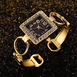 Macro shot of square gold bangle watch with diamond bezel and black rippled dial details