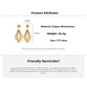 Detailed view showing the 7.7cm length and rhinestones of the gold drop earrings