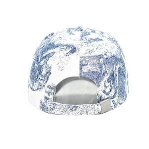 Detail view of adjustable strap and silver metal buckle on a blue toile pattern cap