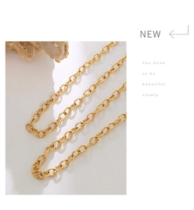 Detail showing 18K gold-plated textured chain link with matte knurled metal finish
