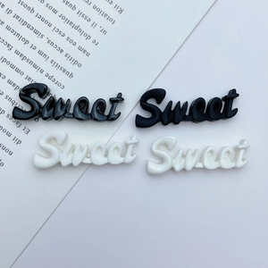 Detail of sweet letter resin charms in black and white for DIY phone case making