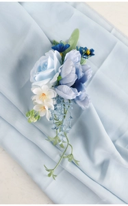 Detail of bridal blue rose and peony floral corsage with silk petals and leaves