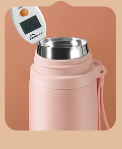 Macro shot of a pink matte insulated water bottle showing inner layer and thermometer reading 65°C