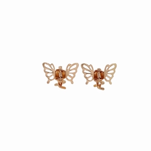 Pair of gold metal butterfly hair claws for women on white background minimalist style