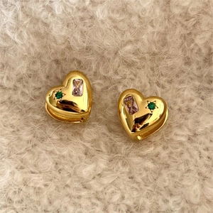 925 silver heart studs with pink and green stones on a soft beige background