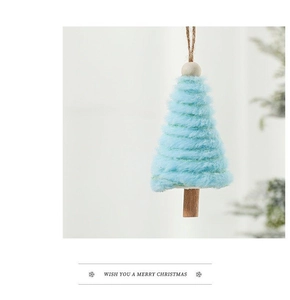 Close-up of light blue plush Christmas tree ornament with wooden base and natural beads