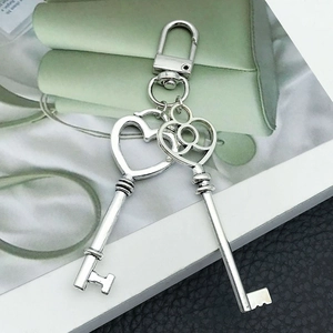 Silver vintage key charms set with heart and floral designs and lobster clasp