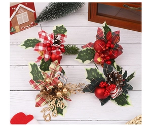 Close-up of Christmas floral picks with red plaid petals, berries, and pine cones