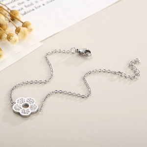 Close-up of a silver floral bracelet with sparkling rhinestones and an adjustable chain