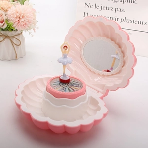 Pink shell music box detail with a rotating ballerina and built-in circular mirror