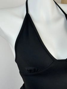 Close-up of black deep V-neck halter top made of premium elastic knitted fabric
