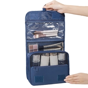 Blue hanging travel toiletry bag with multiple compartments and hook for organization