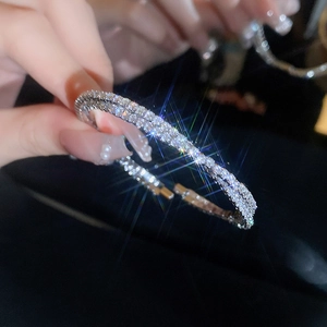 Detailed close-up of double-layer silver zircon bracelet featuring a crisscross pavé design