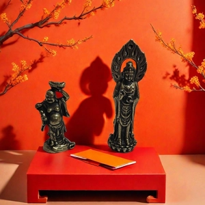 Close-up of vintage bronze Buddha statues including Maitreya and Guanyin on wood base
