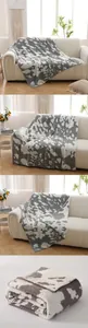 Close-up of thick grey cow print fleece blanket with high color fastness and soft texture