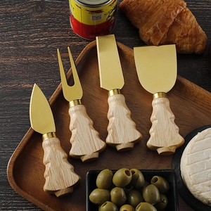 Detail of 4-piece cheese knife set with Christmas tree wood handles on a rustic tray