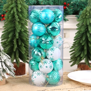 Teal and white Christmas ornaments set in various finishes on a rustic burlap base