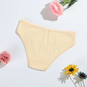 Detailed close-up of ribbed cotton women's briefs in beige with floral decor