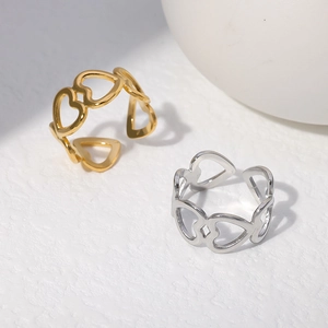 Detail of adjustable hollow heart rings in polished gold and silver stainless steel