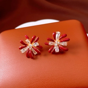 Detail of red flower stud earrings with 18k gold plating and sparkling zircon stones