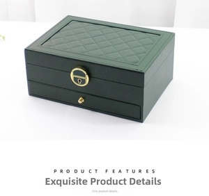 Close-up of green leather jewelry box featuring quilted top and golden metal lock