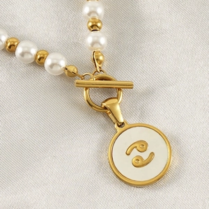 Detailed macro view of 18K gold plated constellation pendant with white shell inlay