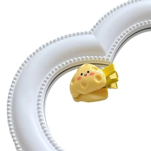 Cute yellow cheese hair clip with cartoon smiley face on a decorative heart frame