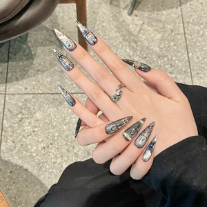 Dark grey glitter stiletto press-on nails with vintage Egyptian cat and eye totems