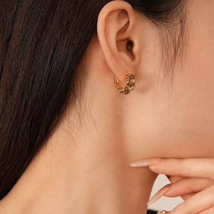 Elegant gold earrings with champagne crystals in a vintage French style shown on model