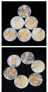 Macro detail of six clear quartz discs with gold engraved tree of life and moon symbols