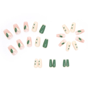 Coffin shaped press-on nails in vintage green and cream pink with heart and cross patterns