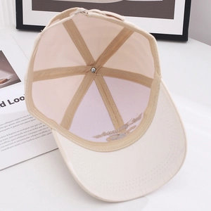Detail view of beige baseball cap interior structure with stitching and adjustable metal buckle