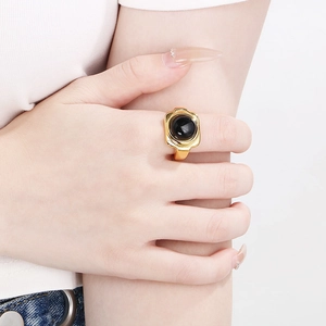 Macro view of vintage 18K gold plated stainless steel ring with round black agate stone
