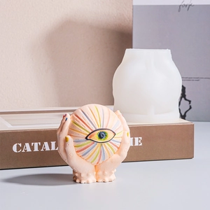 Detail view of eye and hands sculpture silicone mold for DIY candle and resin art