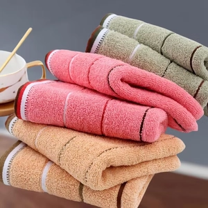 Soft absorbent cotton towels in pink, green and beige with classic striped edges