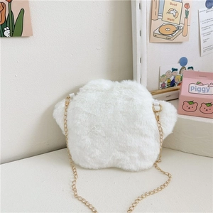 Close-up of white star-shaped plush crossbody bag with delicate gold chain strap