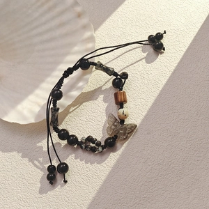 Retro ink-style beaded bracelet with butterfly pendant and wooden beads on woven rope