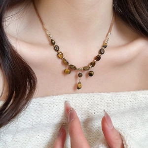 Tiger eye stone tassel necklace with zircon on a model for a vintage aesthetic look