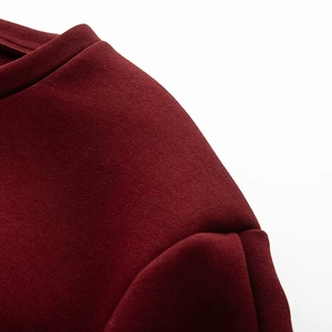 Vue détaillée de la texture du sweat-shirt bordeaux et des coutures de l'épaule