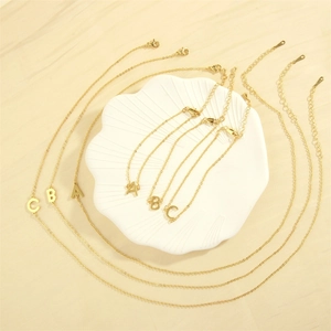 Detail of 18K gold plated letter pendants A, B, C on a chain with lobster clasp