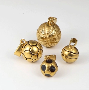 Detailed view of 24K gold plated basketball and soccer pendants with textured patterns