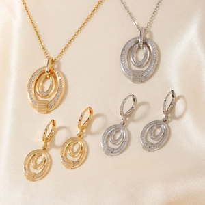 Elegant gold and silver oval pendant necklaces and earring sets with micro-pave crystals