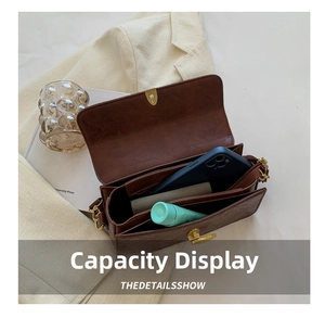 Top view of the brown vintage crossbody bag interior showing compartments and storage capacity