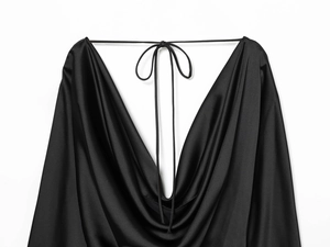 Detail of silk satin backless dress featuring deep V-cut and crisscross tie-up strings