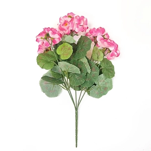 Close-up of artificial pink geranium bouquet with realistic green leaves on white background