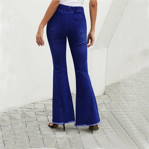 Detail shot of high waisted blue denim flare jeans with back pockets and frayed hemline