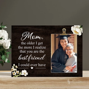 Detail of wooden photo frame with Mother's Day message and metal clip holding a picture