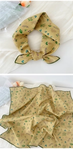 Detailed view of yellow linen-cotton scarf with rabbit and floral prints and green borders
