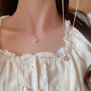 Detail of 18k gold and silver plated square pendant necklaces with cubic zirconia